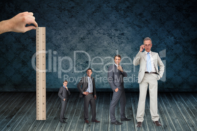Composite image of hand measuring stages of businessmans life with ruler