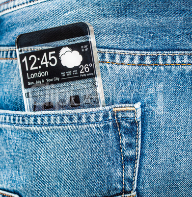 Smartphone with a transparent screen in a pocket of jeans.