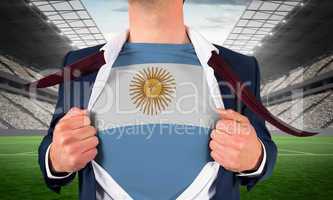 Businessman opening shirt to reveal argentina flag