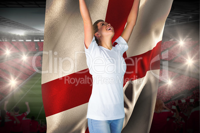 Pretty football fan in white cheering holding england flag