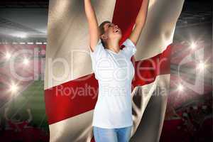 Pretty football fan in white cheering holding england flag