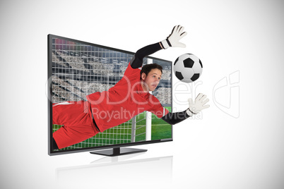 Fit goal keeper saving goal through tv