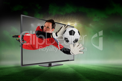 Fit goal keeper saving goal through tv