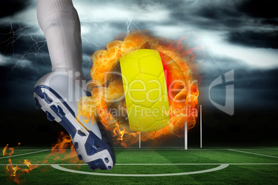 Football player kicking flaming belgium flag ball