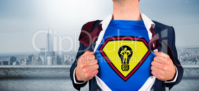 Composite image of businessman opening shirt in superhero style