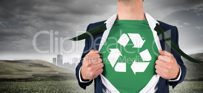 Composite image of businessman opening shirt in superhero style