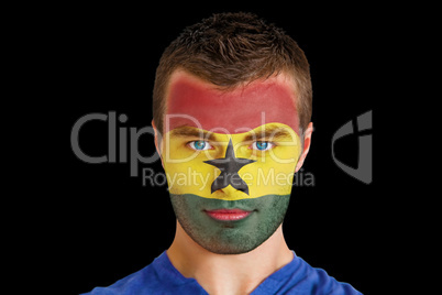 Serious young ghana fan with facepaint