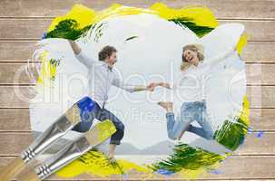 Composite image of couple jumping on the beach