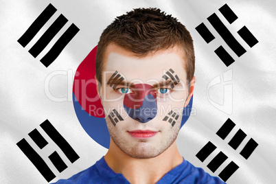 Serious young football fan in face paint