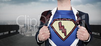 Composite image of businessman opening shirt in superhero style