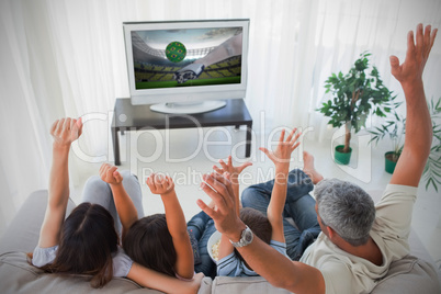 Family cheering and watching the world cup at home