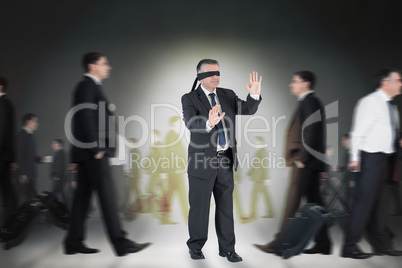 Composite image of mature businessman in a blindfold