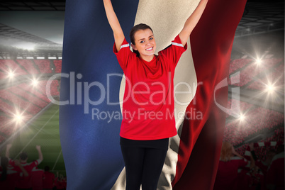 Excited football fan in red cheering holding france flag