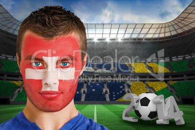 Serious young switzerland fan with facepaint