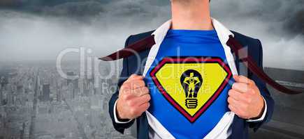 Composite image of businessman opening shirt in superhero style