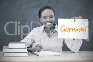 Happy teacher holding page showing german