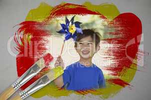 Composite image of little boy with pinwheel