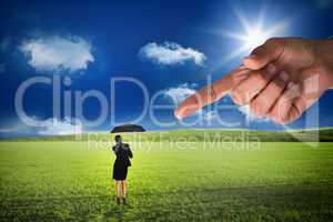 Giant hand pointing at young businesswoman holding umbrella