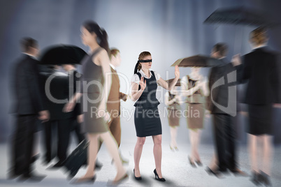 Composite image of redhead businesswoman in a blindfold