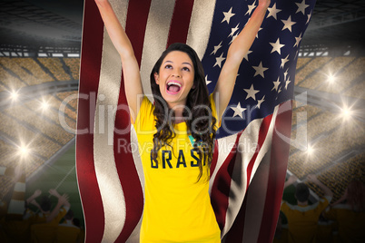 Excited football fan in brasil tshirt holding usa flag