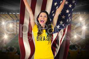 Excited football fan in brasil tshirt holding usa flag