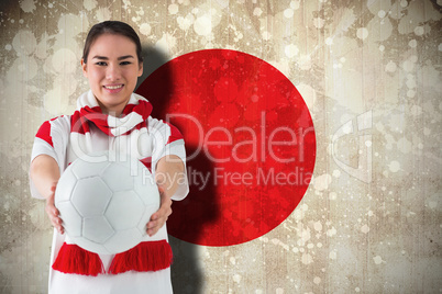 Football fan in white wearing scarf holding ball