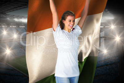 Pretty football fan in white cheering holding ivory coast flag