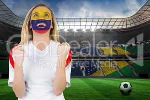 Excited colombia fan in face paint cheering