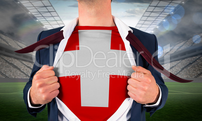 Businessman opening shirt to reveal swiss flag