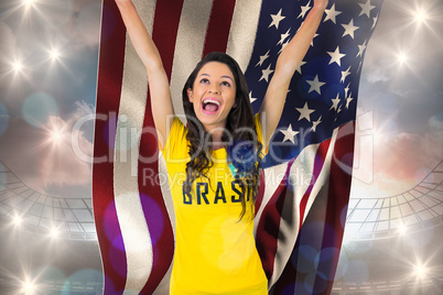 Excited football fan in brasil tshirt holding usa flag