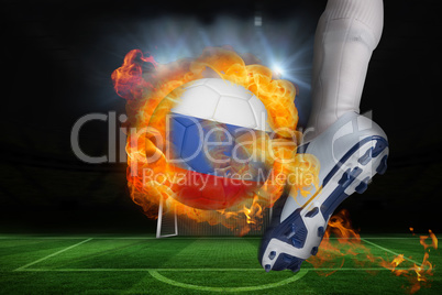 Football player kicking flaming russia flag ball