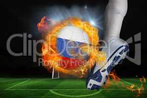 Football player kicking flaming russia flag ball