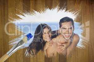 Composite image of attractive couple at the beach