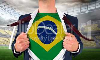 Businessman opening shirt to reveal brasil flag