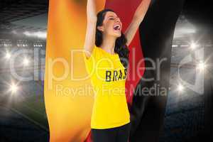 Excited football fan in brasil tshirt holding germany flag