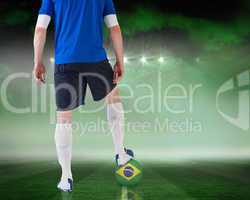 Football player standing with brasil ball