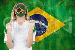 Excited brasil fan in face paint cheering