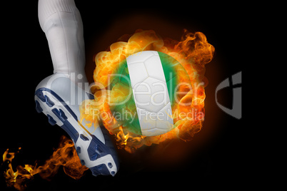 Football player kicking flaming nigeria ball