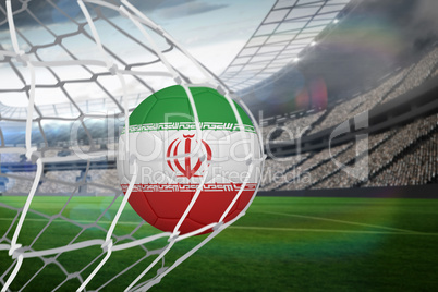 Football in iran colours at back of net