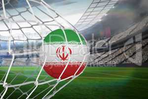 Football in iran colours at back of net