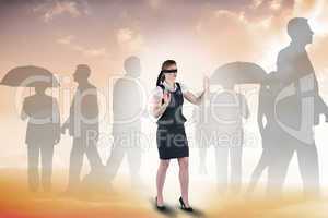 Composite image of redhead businesswoman in a blindfold