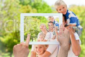 Composite image of hand holding tablet pc