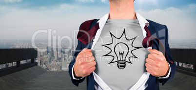 Composite image of businessman opening shirt in superhero style