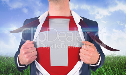 Businessman opening shirt to reveal swiss flag