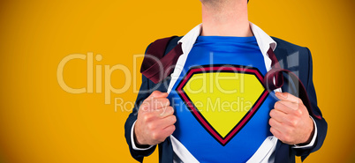 Composite image of businessman opening shirt in superhero style