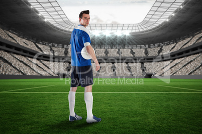 Handsome football player in blue jersey