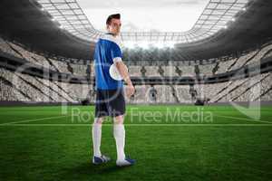 Handsome football player in blue jersey