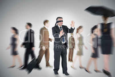 Composite image of mature businessman in a blindfold