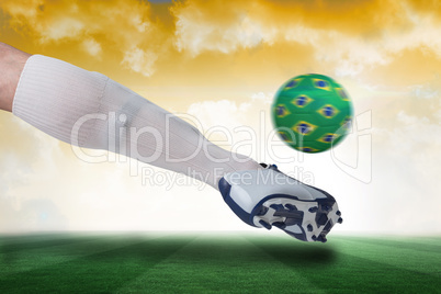 Close up of football player kicking brazil ball