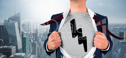 Composite image of businessman opening shirt in superhero style